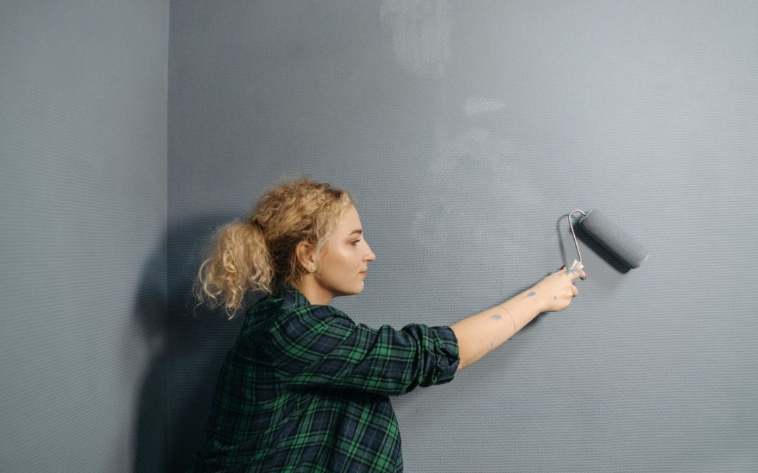 Professional painter applying a smooth wall finish