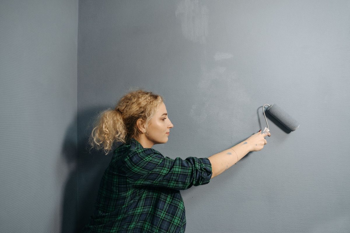 Professional painter applying a smooth wall finish